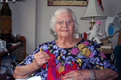 Doll Lady
Ms. Antoinette Boissoneau, a patient at the Sippican Healthcare Center, poses with one of her handmade yarn dolls that she makes for local children. (Photo by Sarah K. Taylor).
