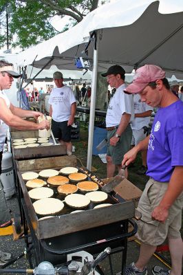 Pancakes in the Park
The popular Sunday morning Pancake Breakfast was a major attraction of this year's annual seaside Harbor Days festival, sponsored by the Mattapoisett Lions Club, which was held in Shipyard Park on the weekend of July 20-22. The event drew thousands of people who enjoyed craft booths, great food, amazing entertainment, and some hometown pride. (Photo by Sylvia Fales).

