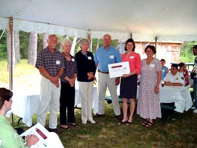 Preserving Open Space
Christopher Makepeace, Joanna Bennett, Zelinda Douhan, and Richard Canning from the Makepeace Neighborhood Fund present a check to Erin Bryant and Susan Adams on behalf of the Rochester Land Trust. The $7,500 grant will be used to preserve open space in the Town of Rochester. (Photo courtesy of Susan Adams).

