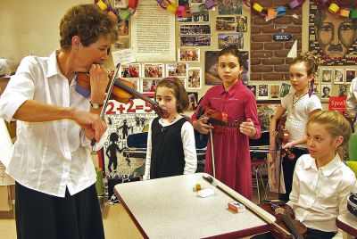 Strings Attached
Music teacher Jean West leads students in playing selections on the violin. Ms. West, together with Old Hammondtown School Band Director Stan Ellis, have teamed up to form and advise the new Old Hammondtown School Orchestra, a program which is a rarity for elementary-level music students. (Photo by and courtesy of Laura McLean).
