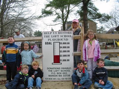 Playground Pledge
Loft School students (back row, l. to r.) Henry Ucci, Caroline Walsh, Mia Beams, (front row, l. to r.) William Garcia, Seamus Fearons, Sam Gordon and John Egger pose with the fundraising sign at the school playground in Marion which they hope will soon be renovated and improved. Behind the sign is the schools President of Fundraising Jill Fearons. (Photo by Nancy MacKenzie).
