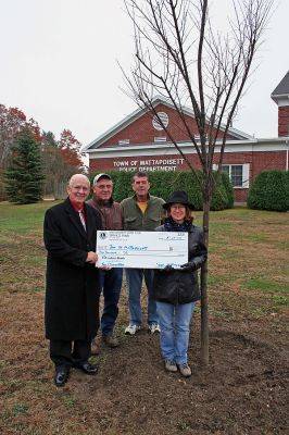Police Planting
The Mattapoisett Lions Club, represented by chapter president Steve Magyar (far left), recently presented a replica check for $300 to Mattapoisett Tree Warden Roland Cote and Mattapoisett Tree Committee members Sandy Hering and Ed Walsh, to pay for a recently-planted Princeton Elm at the Mattapoisett Police Station on Route 6. (Photo by Robert Chiarito).
