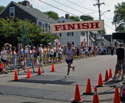 2007 Mattapoisett July 4 Road Race
Jeff Reed of Fall River crosses the finish line in the 37th annual Mattapoisett July 4 Road Race, finishing third overall in 27:52 with a pace of 5:35. (Photo by Kenneth J. Souza).
