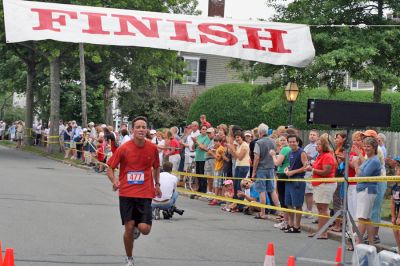 Mattapoisett Road Race 2008
Jared Dourdeville of Marion crosses the finish line in 29:54 to place seventh overall in the Mattapoisett Road Race held on July 4, 2008. (Photo by Kenneth J. Souza).
