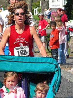 Mom's Marathon '07
An estimated 400 runners and walkers came out to the Oxford Creamery in Mattapoisett on Sunday, May 13 to participate in the first annual Tiara Classic Mothers Day 5K Road Race. The most impressive feat of the day was accomplished by runner Mary Cass (above) who won the womens portion of the race, outdistancing the competition by several hundred feet while pushing her daughters, Acadia and Naomi, in a jogging stroller. (Photo by Robert Chiarito).
