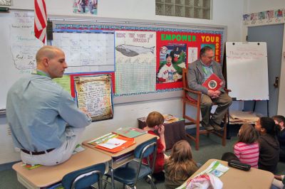 Readers in Rochester
Rochester Selectman Dan McGaffey reads to students at Rochester's Memorial School during the recent "Reading is Fundamental" guest reader program. (Photo by Robert Chiarito).
