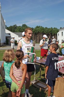 Rochester 5K Winner
Julien Di Maria proudly accepts the first place trophy in the 2008 Rochester Road Race 5K held on Saturday, August 16. Di Maria finished the 3.1-mile trek in 16:41. (Photo by Olivia Mello).
