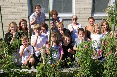 Student Gardeners
A group with "green thumbs"... the staff, parents and students who worked on the garden at Sippican School in Marion during the summer months hold the "fruits of their labor." (Photo by Jane McCarthy).
