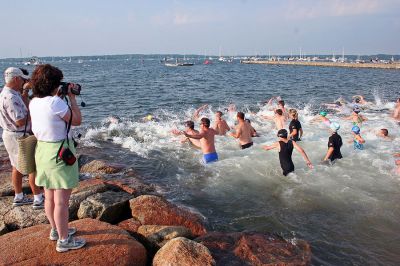 Triple Challenge
Participants in the 2007 annual Mattapoisett Lions Club Triathlon dive into the waters of Mattapoisett Harbor on Sunday morning, July 15 for the first challenge in the triple event. (Photo by Robert Chiarito).
