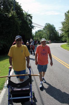 7,000th Mile
Brad Hathaway, 92, walked his 27,000th mile on Saturday, surrounded by a gathering of family and friends while promoting the Priscilla Hathaway Art Scholarship in memory of his late wife. Photos by Mick Colageo
