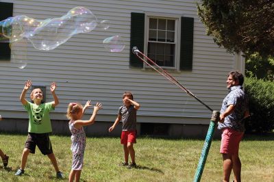 Keeping it cool
Kids gathered outside the Joseph H. Plumb Memorial Library on Friday, July 21, chilling in the shade drenched in bubble stuff with Vinny the Bubble Guy. Photos by Jean Perry
