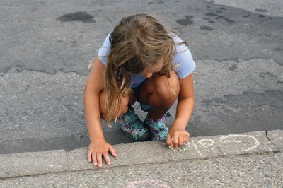 Chalk It Up
The day before the Marion Town Party, kids chalked-up the sidewalks in front of the Marion Town House in preparation for the Saturday night event. Town Party Planning Committee members set up picnic tables and strung party lights in the background while the kids drew colorful, festive pictures with chalk. Photos by Jean Perry
