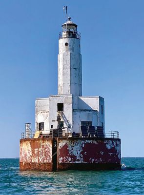 Cleveland Ledge Lighthouse
Painting crew on the Cleveland Ledge Lighthouse, waving away dangerously close boaters. Photo by Mary Dermody
