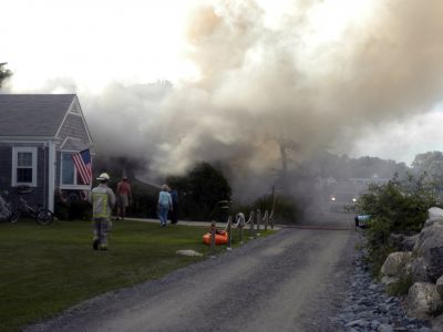 Bay Road Fire
The Mattapoisett Fire Department responded to a house fire on Bay Road at Point Connett around 7pm on Thursday July 22, 2010. The front of the structure was heavily damaged but the Fire Department was able to quickly contain the fire and keep it from spreading to neighboring homes. Photo by Paul Lopes
