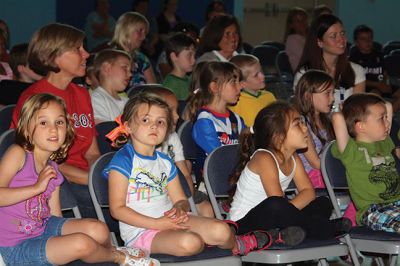 Lighten Up
Third-graders on June 16 performed their play “Lighten Up,” donning rainbow wigs, gigantic glasses, tutus, and brightly colored mustaches to remind everyone to not take themselves so seriously all the time. The students sang silly songs, told jokes, and offered some valuable advice like, “When life makes you sweat, wear deodorant!” By Jean Perry
