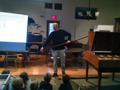 Marion Natural History Museum
Dr. Michael Moore of Woods Hole Oceanographic Institute, using the museum's harpoon and baleen, introduced the Marion Natural History Museum's after-school group to a little of Marion's whaling history. Students could ask questions and theorize why Sippican Harbor had the first recorded visit from a humpback whale this fall. We wish to thank Dr. Moore for the great program. Photo courtesy Elizabeth Leidhold
