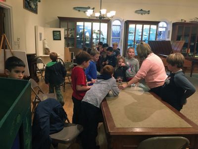 Marion Natural History Museum
Students of the Marion Natural History Museum's afterschool group learned about cranberry farming with Dawn Gates-Allen of the Cape Cod Cranberry Growers Association. We "bounced" and floated cranberries to determine if they were good and learned a little about the bugs of the bog, including IPM (Integrated Pest Management) techniques. Many thanks to Dawn for her fun and informative program. Photo courtesy Elizabeth Liedhold
