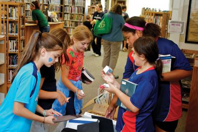 Summer Reading Program
Several Rochester youths who participated in the "Dream Big: Read" summer reading program peruse boxes of books at Plumb Library on Saturday, September 15, 2012.   
