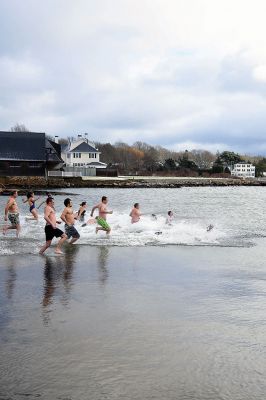 Christmas Day Swim
The Helping Hands and Hooves’ annual Christmas Day Swim was preceded by a polar plunge in the weather and a brief ‘snownado’ of sorts as the winds swept snow and sleet across the area only minutes before enthusiastic participants in costume arrived at the Mattapoisett Town Beach and raced into the icy waters. Photos by Glenn C. Silva
