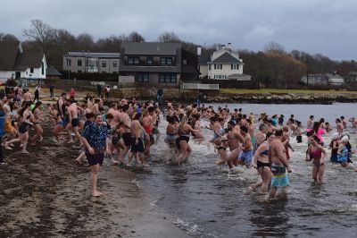 Polar Plunge
On New Years Day, hundreds were arrayed at Mattapoisett Town Beach for this year’s Mattapoisett Polar Plunge. Since 2013, the beach has seen residents and visitors run into the freezing Atlantic to kick off the new year. The event is held by Keep On Plungin’ who, through the selling of baked goods, coffee, and hot chocolate, donate all proceeds of the fridged plunge to local families grappling with the costs of cancer treatment. Photo by Sam Bishop.
