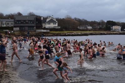 Polar Plunge
On New Years Day, hundreds were arrayed at Mattapoisett Town Beach for this year’s Mattapoisett Polar Plunge. Since 2013, the beach has seen residents and visitors run into the freezing Atlantic to kick off the new year. The event is held by Keep On Plungin’ who, through the selling of baked goods, coffee, and hot chocolate, donate all proceeds of the fridged plunge to local families grappling with the costs of cancer treatment. Photo by Sam Bishop.
