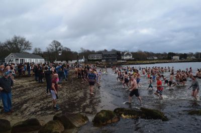 Polar Plunge
On New Years Day, hundreds were arrayed at Mattapoisett Town Beach for this year’s Mattapoisett Polar Plunge. Since 2013, the beach has seen residents and visitors run into the freezing Atlantic to kick off the new year. The event is held by Keep On Plungin’ who, through the selling of baked goods, coffee, and hot chocolate, donate all proceeds of the fridged plunge to local families grappling with the costs of cancer treatment. Photo by Sam Bishop.
