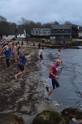 Polar Plunge
On New Years Day, hundreds were arrayed at Mattapoisett Town Beach for this year’s Mattapoisett Polar Plunge. Since 2013, the beach has seen residents and visitors run into the freezing Atlantic to kick off the new year. The event is held by Keep On Plungin’ who, through the selling of baked goods, coffee, and hot chocolate, donate all proceeds of the fridged plunge to local families grappling with the costs of cancer treatment. Photo by Sam Bishop.
