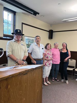 Purple Heart
An old image of war hero Edward D. Kinney Jr. was shared as family members and a supportive gathering crowded the Mattapoisett Free Public Library on August 10 as six Purple Heart recipients were honored by the Town of Mattapoisett. Photo by Marilou Newell
