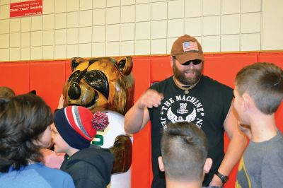 “The Machine” Jesse Green
Famous chainsaw artist and star of the National Geographic Channel TV show American Chainsaw, “The Machine” Jesse Green presented the RMS students with a one-of-a-kind chainsaw sculpture of Bandit, the RMS mascot, on December 15. Bandit will stand firm and tall (much taller than most of the students) at the school from now on, thanks to the coordination of the RMS PTO. Photos by Jean Perry
