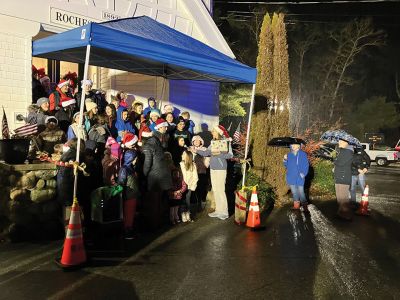 Annual Tree Lighting
Rochester Memorial School students singing Christmas songs under a blue canopy at the Rochester Town Hall. Photo by Mike Decicco.
