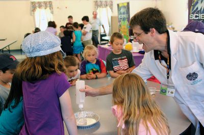 Mad Scientist
 The Joseph H. Plumb Library in Rochester kicked off their summer reading program entitled “Dig Into Reading” last Friday evening at the Congressional Church, where “Mad Scientist” Laser Leigh presented a group of K-6 graders from the Tri-Town area with several scientific experiments and an informative-yet-fun lecture on the wide scientific world. Photos by Nick Walecka. 
