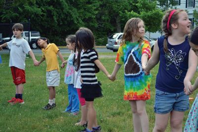 Field Day Fun at Sippican School 
Friday morning we caught some first-graders in the middle of a hula-hoop relay on the grounds of Sippican School. Holding hands and cheering each other on, the kids twisted and turned themselves through the hoops and the first team to get their hoop to travel down and up the line again won the relay. Can you guess which team won? Photo by Jean Perry
