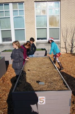 Sippican Gardening
Gardening project recently launched by Nate Sander of The Marion Institute. The children are learning about how the sun and soil work together to produce an environment conducive for plants. Photo by Mick Colageo 
