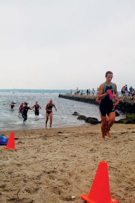 Mattapoisett Lions Club Triathlon
Emily Tato was grateful to Aner Larreategi after their top-three-overall performances in Sunday’s Mattapoisett Lions Club Triathlon. Pushed from start to finish by Larreategi, Tato was the fastest woman in all three events, the swim, bike and run. Don Cuddy was the 70-and-over winner. Photos by Mick Colageo
