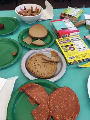 Vegan
To vegan or not to vegan? That was the question taste testers answered when the Mattapoisett Library hosted another chapter of their sustainable initiative programming on February 26. Library Director Jennifer Jones prepared and served vegan substitutes of chicken, hot dogs, sausage, and lunchmeat. The participants nibbled each offering with great anticipation. The overriding takeaway was that some faux meats might be acceptable in a casserole. Photo by Marilou Newell March 3, 2022 edition
