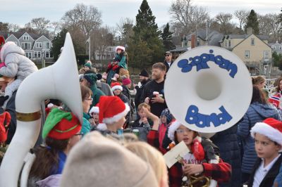 2024 Marion Christmas Stroll 
The 2024 Marion Christmas Stroll took place on December 8. Pictured are Carolers outside The Sippican Historical Society (top), Mr. and Mrs. Clause riding their carriage on Front Street (left), and Santa arriving by tugboat (bottom). Photos by Sam Bishop and Mick Colageo.
