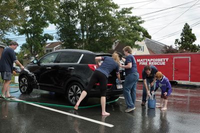 SCC Car Wash
The SouthCoast Children’s Chorus – along with parents and patrons – scrubbed for bucks during a car wash at the Mattapoisett Fire Station on Saturday afternoon, raising money for their general fund with a busy performance schedule coming up. “We hold fundraisers to support the work, the growth, and the performances of the Chorus,” Artistic Director Leslie Piper said. “We want every child to be able to sing, so we offer tuition scholarships for those who need them.” Photo by Shawn Badgley.
