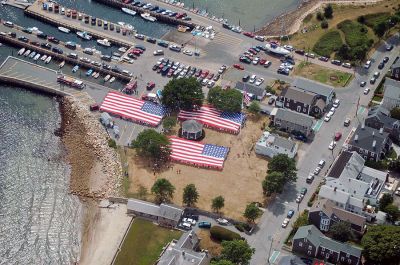 Glory Unfurled
Mattapoisett's weeklong 150th Sesquicentennial Celebration was capped off with a closing ceremony featuring the glorious unfurling of three large versions of the Stars and Stripes, courtesy of the National Flag Truck exhibit, in the area of the Town Wharf and Shipyard Park on Sunday afternoon, August 12. (Photo by Ken Howland).
