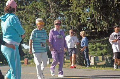 Walk the Line
Rochester residents Dorothy Tuttle and Mary Paynaude were among the many walkers who made the first annual five-kilometer trek during the Rochester Road Race. (Photo by Angela Kantner).
